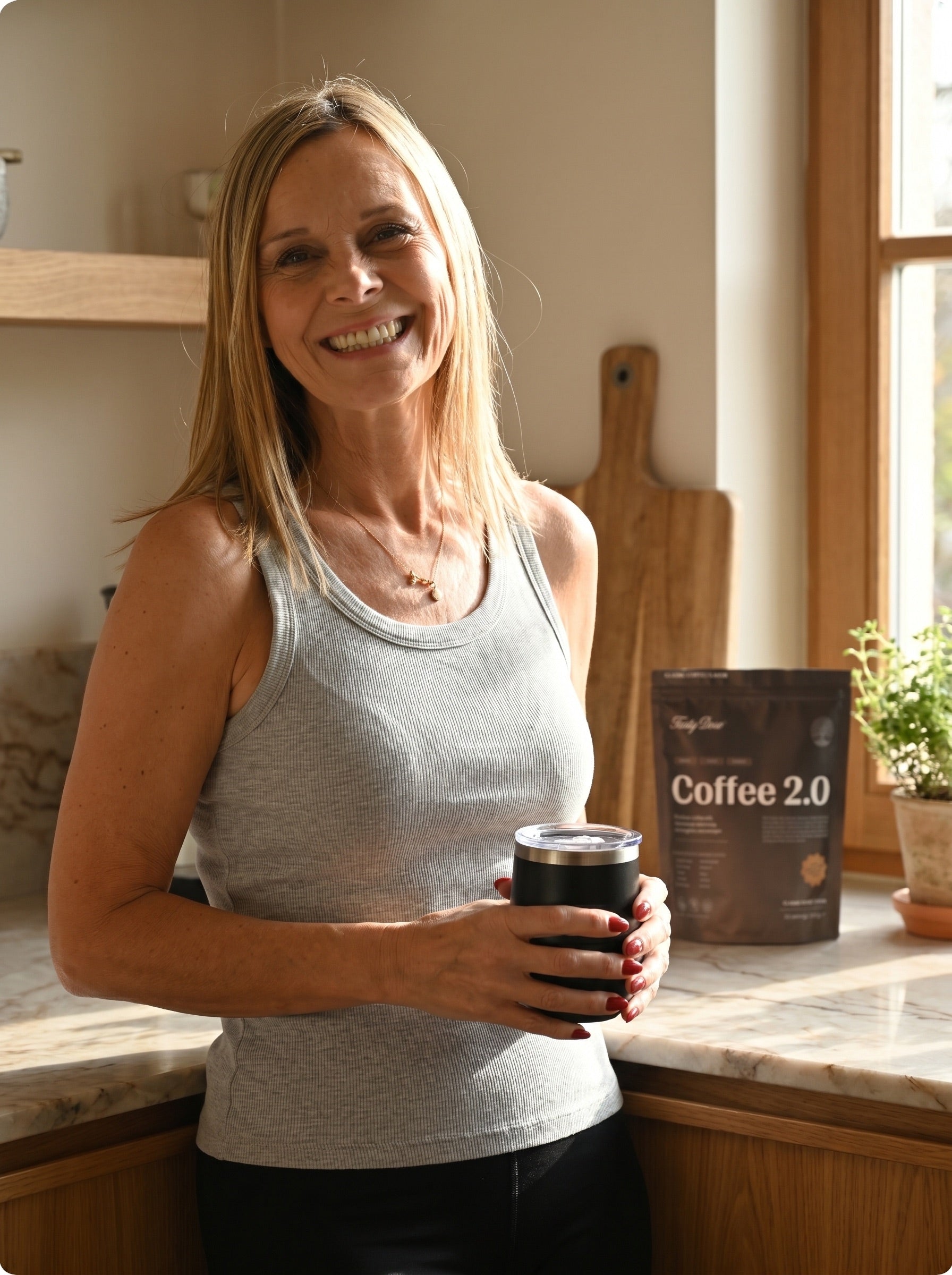 Real Tasty Dose customer smiling with her Coffee 2.0 pouch and tumbler